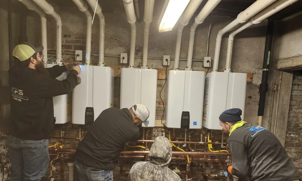 Elite Plumbing and Sewer crew installing wall-mounted tankless water heaters